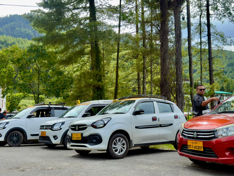 Taxis waiting in front of the Royal Thimphu College's gate