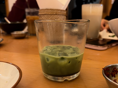 A glass of iced green tea served at restaurant, highlighting beverage choices and changing eating habits among young people in Bhutan.