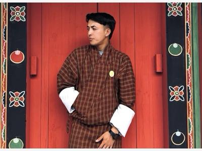Kinley wearing a traditional Bhutanese gho.