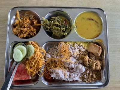 A descriptive text for readers who cannot see the image. “Students buying food and gathering at the Royal Thimphu College canteen.”